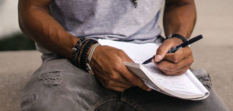 A man writes in a note book - Partial Hospitalization Program