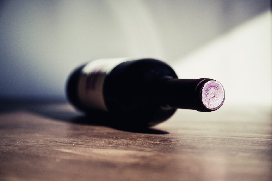 Bottle laying on floor Alcohol Use Disorder concept image