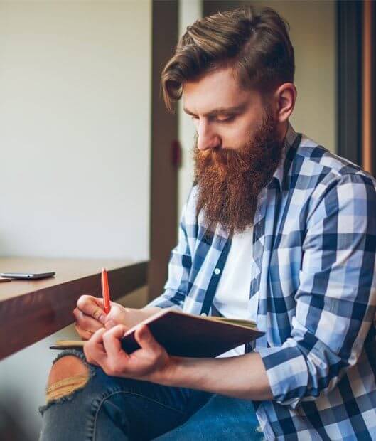 529×540-DIV1 A man writes in a notebook - addiction treatment center in fairfax county concept